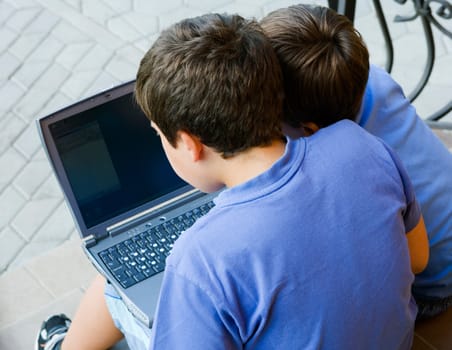 Two cute boy study on computer 