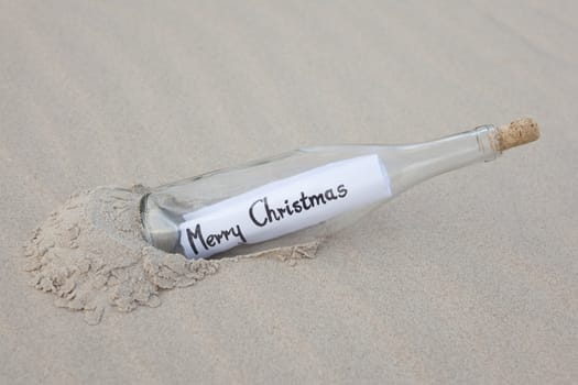 A clear glass bottle washed up on the beach