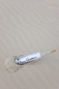 A clear glass bottle washed up on the beach