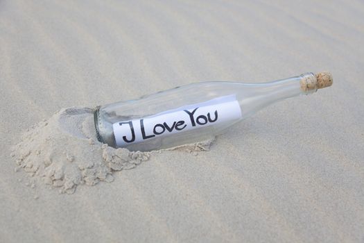 A clear glass bottle washed up on the beach