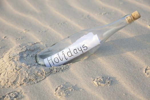 A clear glass bottle washed up on the beach