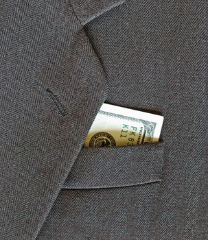 100 dollars, peeking out from the pocket of coat