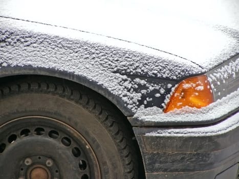 Car at the parking under snow    