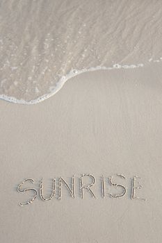 Sunrise written in the beach