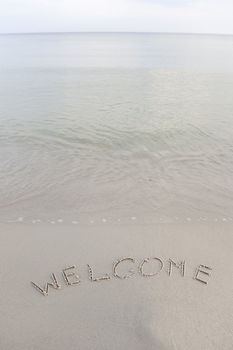 Welcome written in the beach
