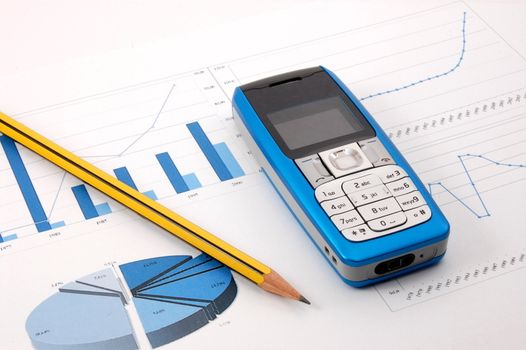 blue cell phone over business chart showing success