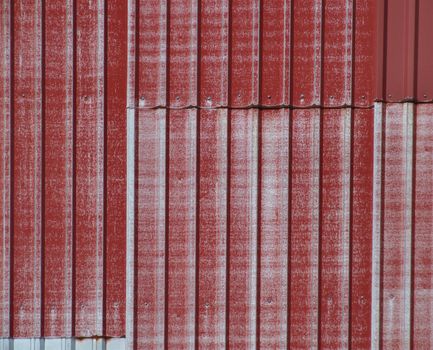 Old metallic surface of a warehouse wall.