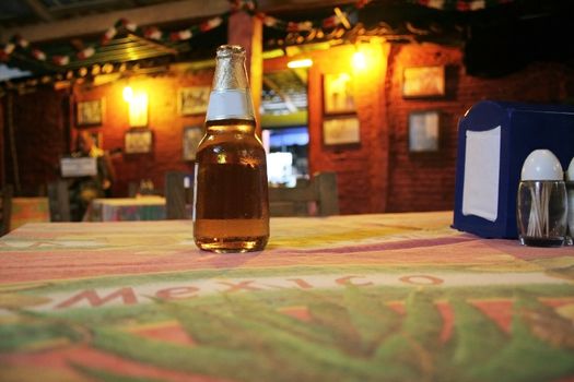 Beer sitting on table in bar in mexico