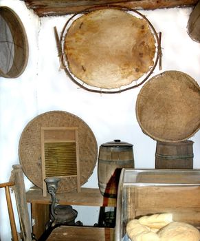 Detail of kitchen in centuries old hacienda, showing table washboard, barrels, and various baskets 