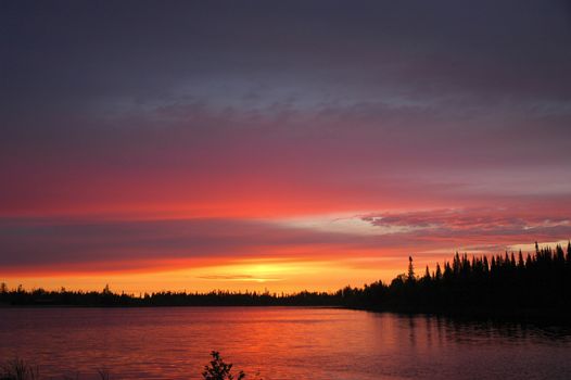 Glowing sunrise reflecting in small lake