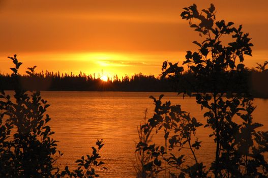 Orange sunrisereflecting in small lake