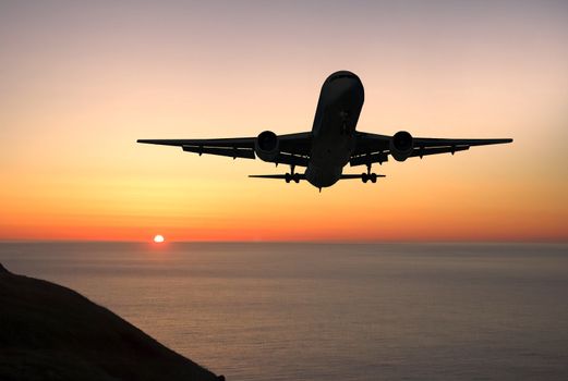 Large airliner approaching to land at sunrise