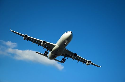 Airplane approaching to land during sunny day