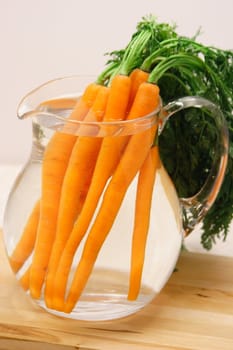 fresh organic carrots in a pitcher