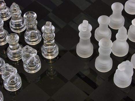 Frosted and clear chess pieces on a glass chessboard. Note the backgammon markings below the surface of the glass.