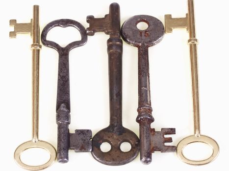 A group of old metal skeleton keys, isolated on a white background.