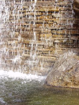 Background of a small waterfall over a stone wall.