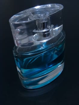 Woman blue parfume against the black background