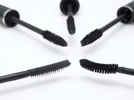 different make-up brushes over the white background
