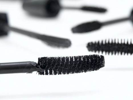 different make-up brushes over the white background