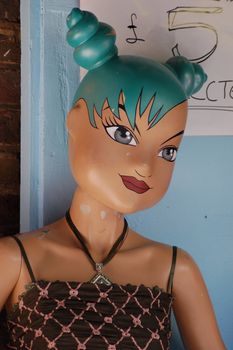 Funky Mannequin outside a shop in Camden Lock with blue Princess Leia hair and giant almond eyes