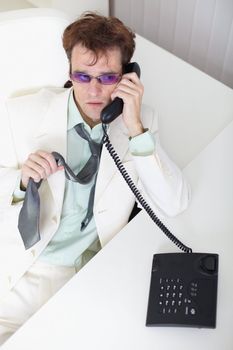 The uneasy young businessman speaks on the phone