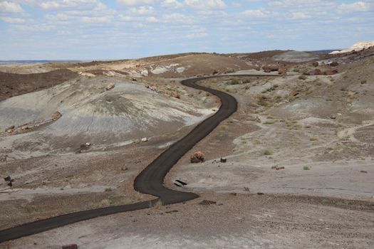 Narrow roadway snakes through the Painted Desert, part of Petrified Forest National Park