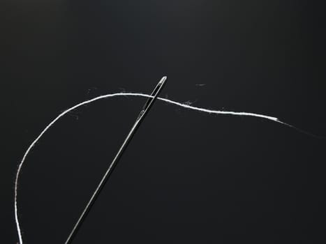 	
steel needle with the white thread through eyelet