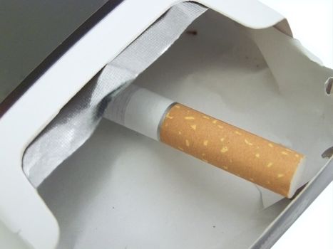 single cigarette in the empty cigarette box