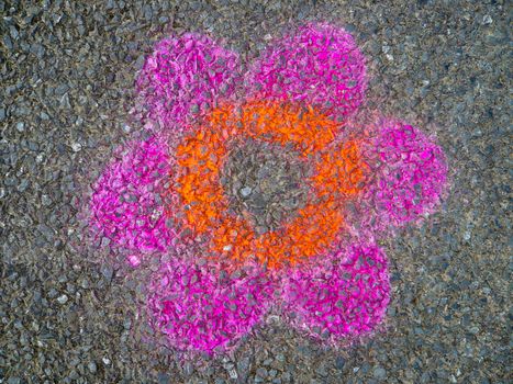 Painting of a colorful flower on a road