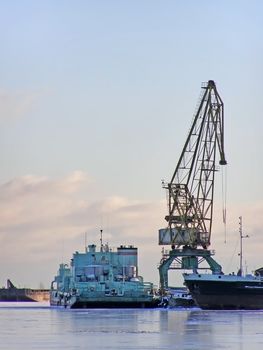 winter cargo side port with big ships and crane