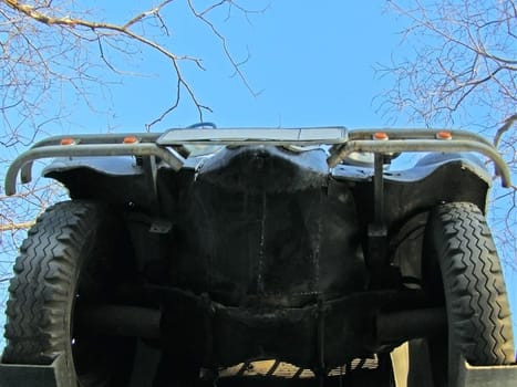 underneath of the car against blue sky