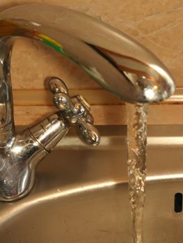 Tap with run water in the kitchen