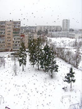 Town view through the window with the drops