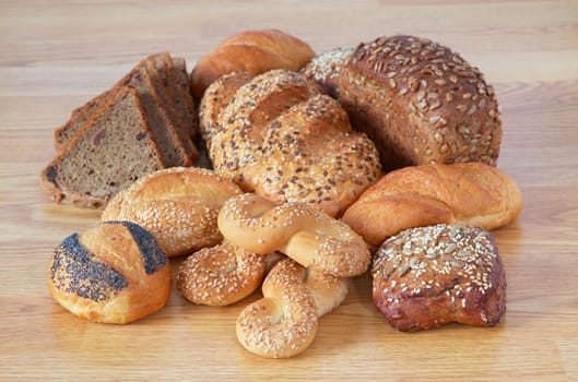 different bread with trip sesame, sunflower, with raisins, shortening on wooden table