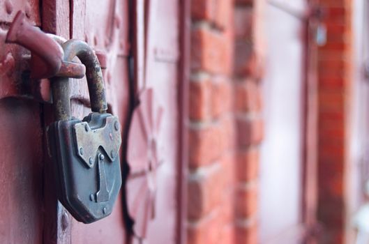 outboard lock on old iron door in wall from red brick