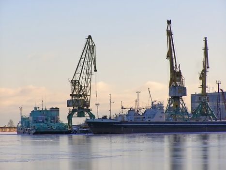 winter cargo side port with big ships and cranes