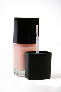 The small bottle with pink nail polish, is used in the course of manicure.