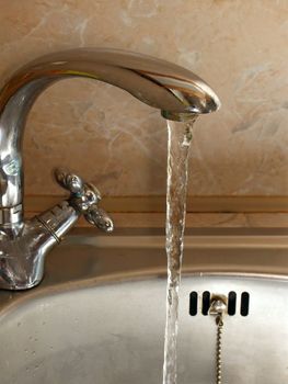 Tap with run water in the kitchen