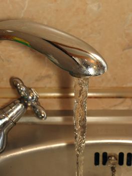 Tap with run water in the kitchen