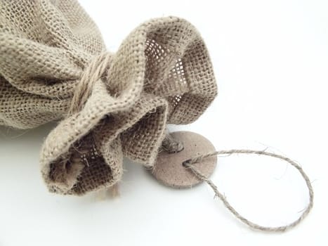 The part of the close beige linen sack with the tag label