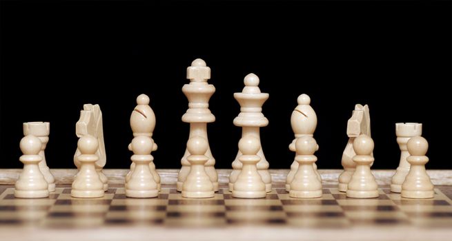 White Chess Pieces On Wooden Chessboard, Focus On Back Row