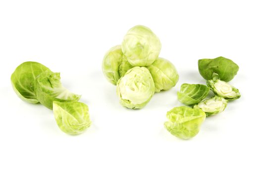 Small raw green sprouts peeled with leaves on a reflective white background