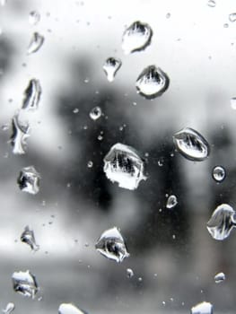 Many rain drops at the window glass
