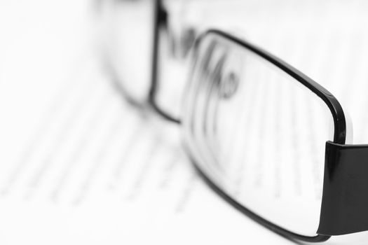 Eyeglasses on open book in black and white