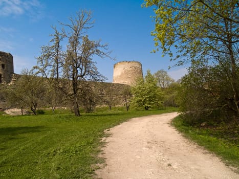 Ancient fortress tower on a spring garden