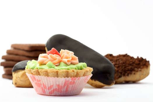 Various sponge cakes and cookies isolated on white background