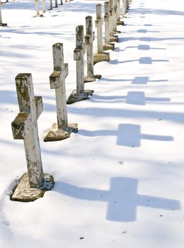 Row of the winter cemetery crosses in sunny day