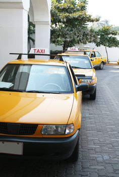 Taxis in a row waiting for a fare