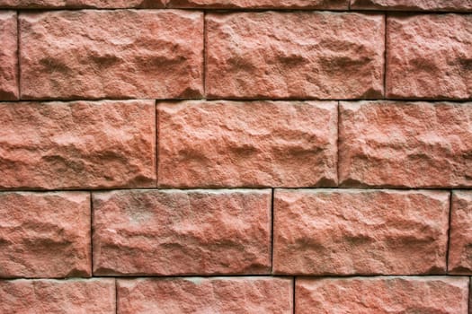 A pattern of red rectangular natural stone textured blocks.